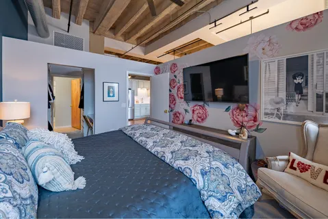 a bedroom with furniture and a flat screen tv