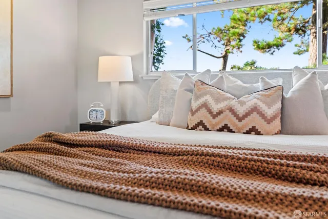 a living room with furniture and view of kitchen