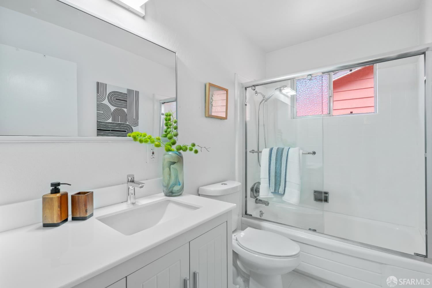 1669 Higgins Way Pacifica, CA 94044 - Photo 23 of 91 a bathroom with a granite countertop sink a toilet a mirror and shower