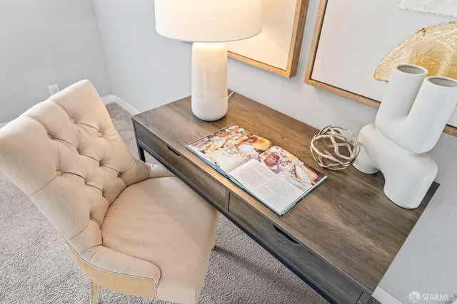 a bedroom with a bed lamps and a large mirror