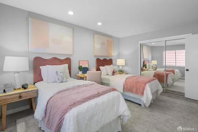 a bedroom with a bed and a potted plant