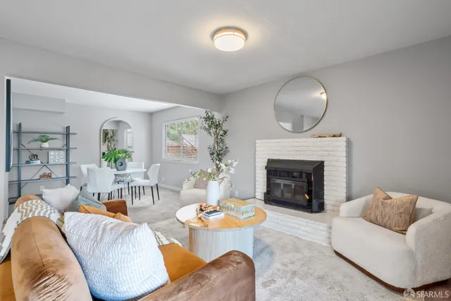 a kitchen with a refrigerator and a wooden floor