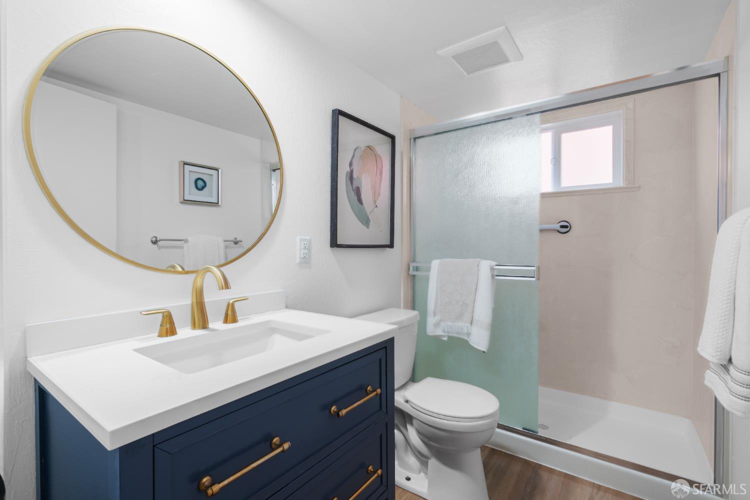 1669 Higgins Way Pacifica, CA 94044 - Photo 41 of 91 a bathroom with a toilet a sink a mirror and vanity