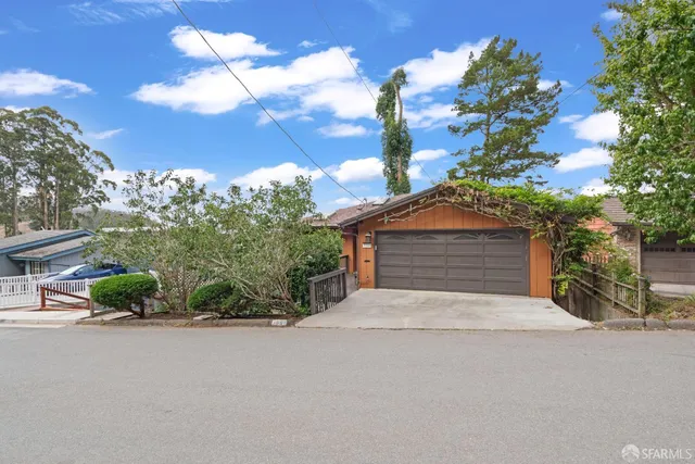 front view of a brick house with a yard