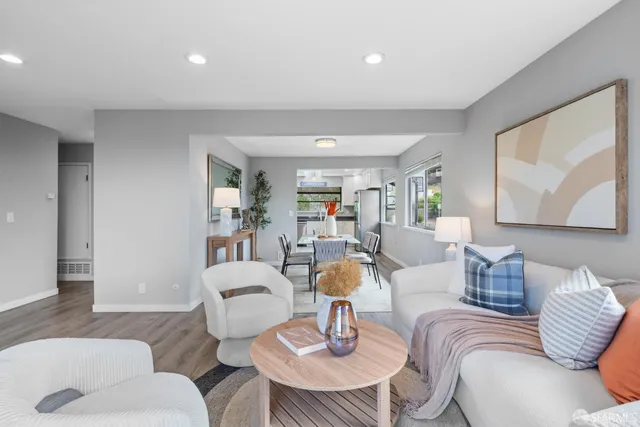 a living room with furniture and a painting on the wall