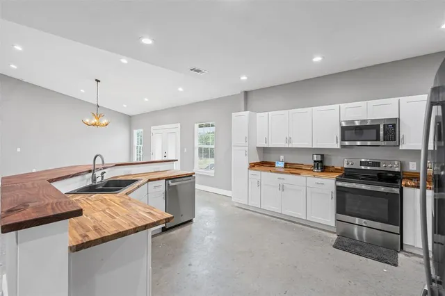 a kitchen with stainless steel appliances granite countertop a sink and a stove