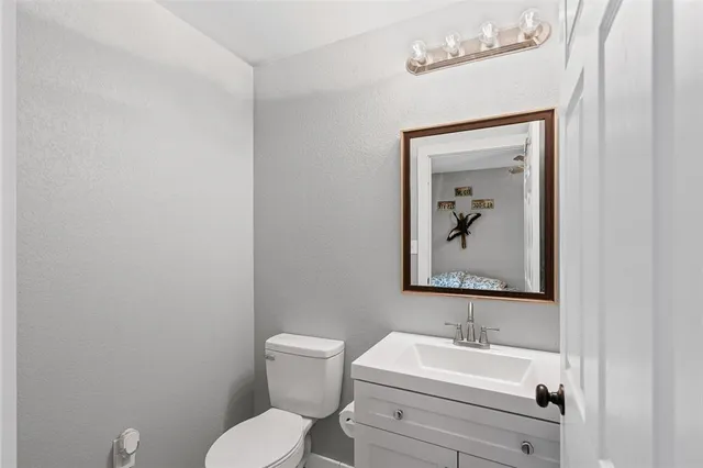 a bathroom with a toilet sink and mirror