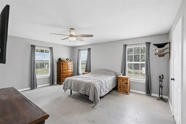 a bedroom with a large bed and a chandelier