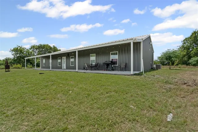 a front view of house with yard outdoor seating and trampoline