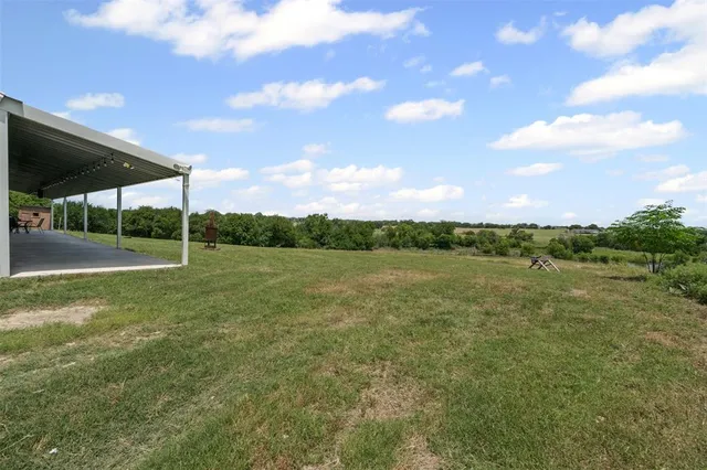 a view of a field with sitting area