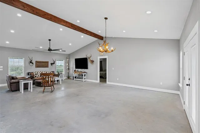 a view of a big room with dining room furniture and a chandelier