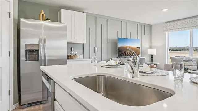 a kitchen with kitchen island a sink stove and refrigerator