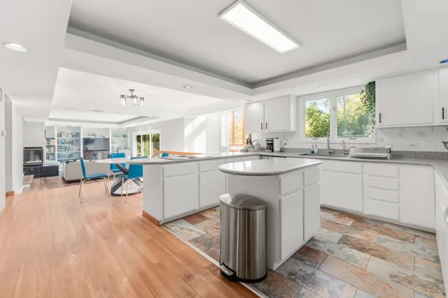a view of a dining room with furniture large windows and wooden floor