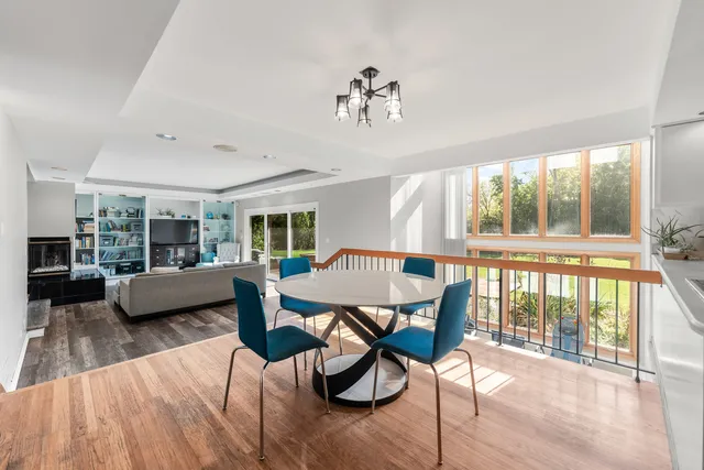 a living room with furniture and a dining table with kitchen view