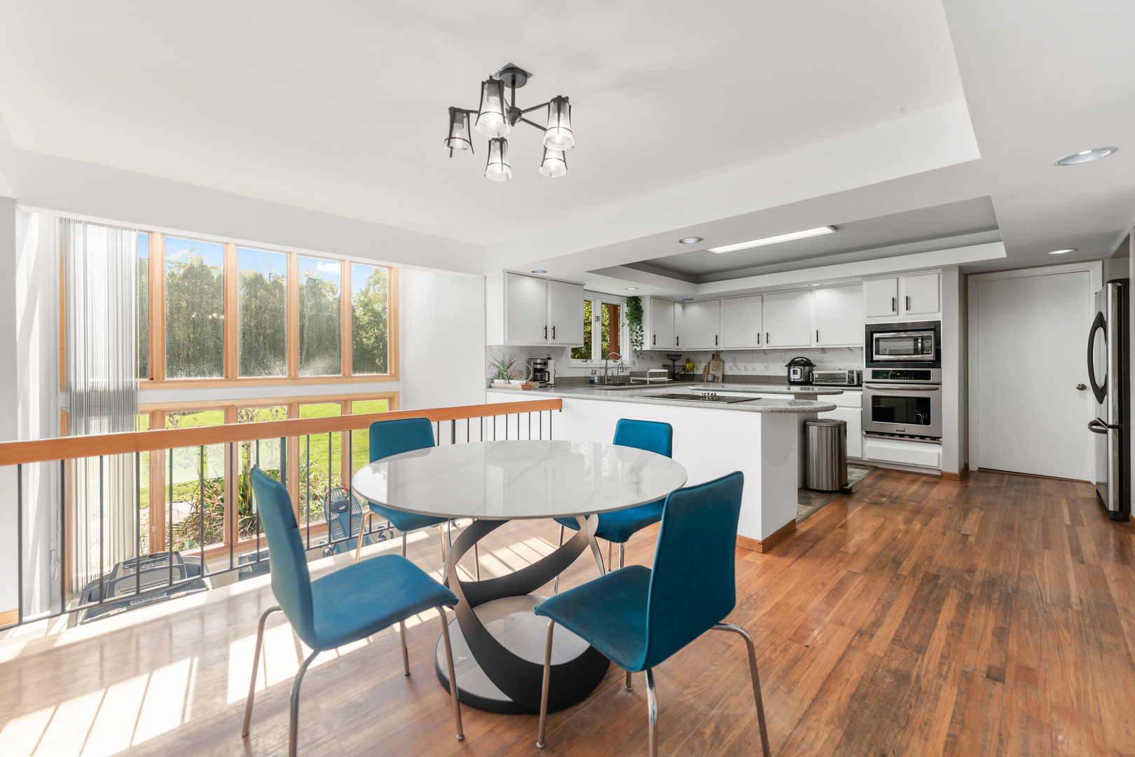 336 Roberts Road Inverness, IL 60010 - Photo 20 of 80 a kitchen with stainless steel appliances granite countertop a stove a sink dishwasher a dining table and chairs with wooden floor