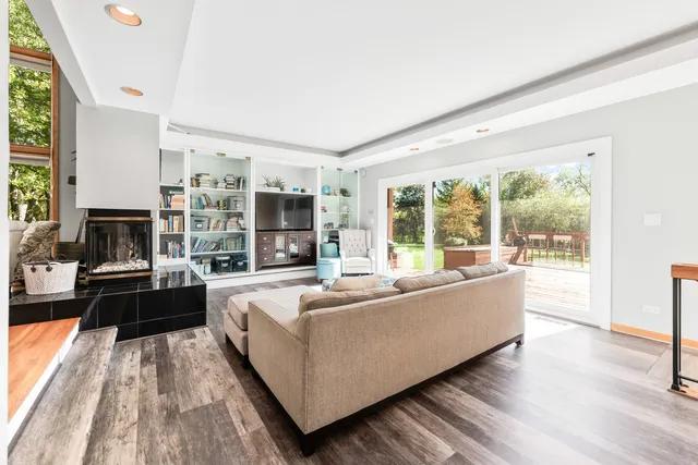 a view of a living room with furniture and floor to ceiling windows
