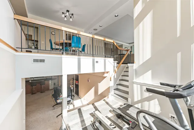 a view of a workspace with furniture and a bookshelf