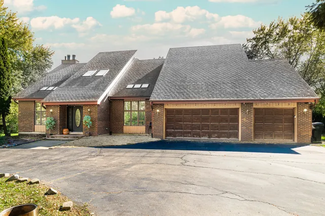 view of a house with a yard and sitting area