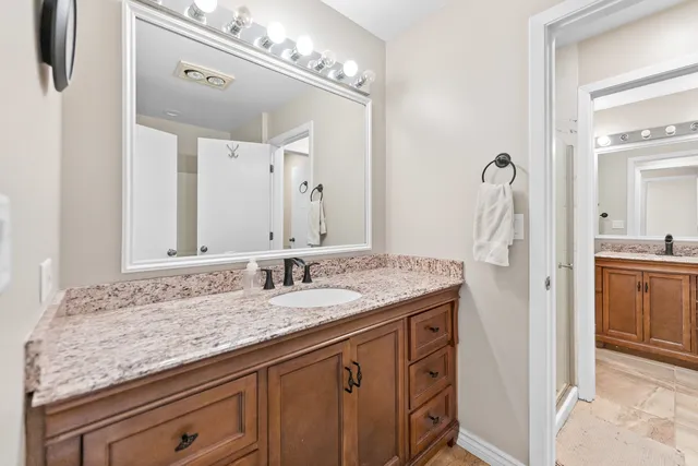 an aerial view of residential houses with outdoor space and trees