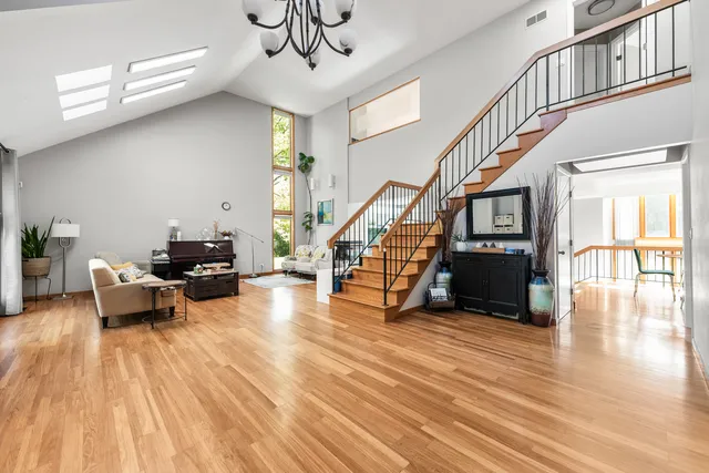 a view of entryway and dining room with wooden floor