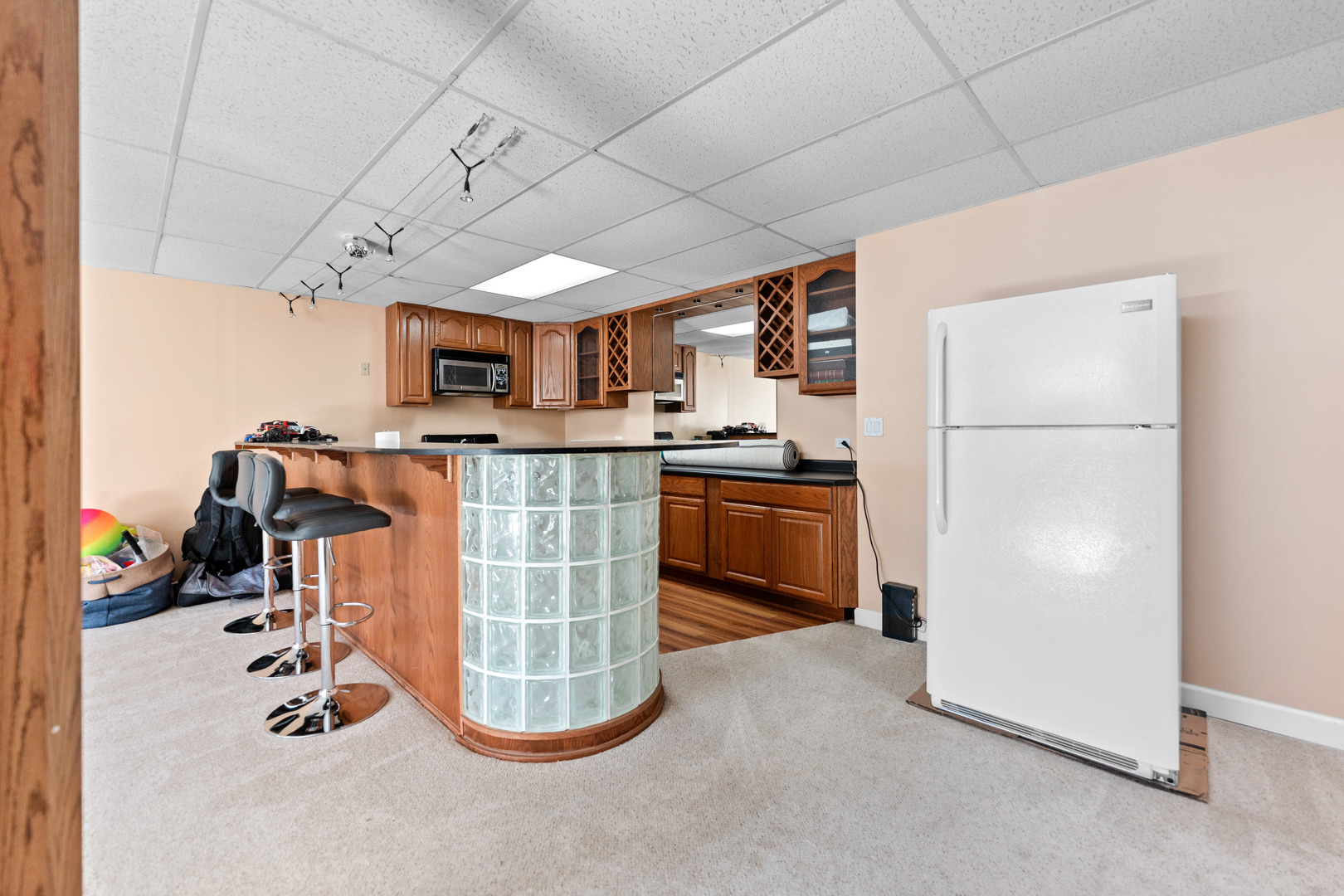 336 Roberts Road Inverness, IL 60010 - Photo 61 of 80 a kitchen with stainless steel appliances granite countertop a refrigerator a stove a sink dishwasher and a dining table with wooden floor