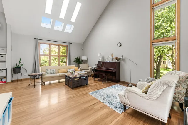 a living room with furniture wooden floor and a large window
