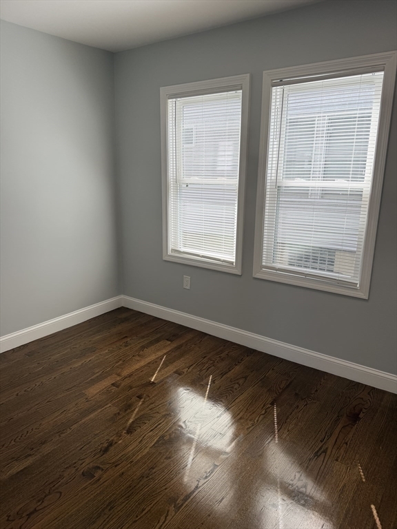 60-62 Wellsmere Road, Unit 2 Boston, MA 02131 - Photo 9 of 19 a view of an empty room with wooden floor and a window