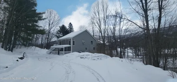a view of a house with a snow in a yard