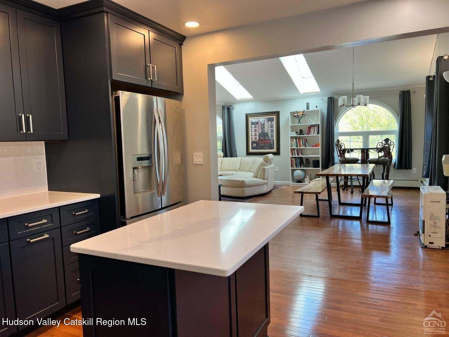 16 Hickory Hill Road Windham, NY 12496 - Photo 11 of 39 a kitchen with stainless steel appliances a table chairs refrigerator and sink