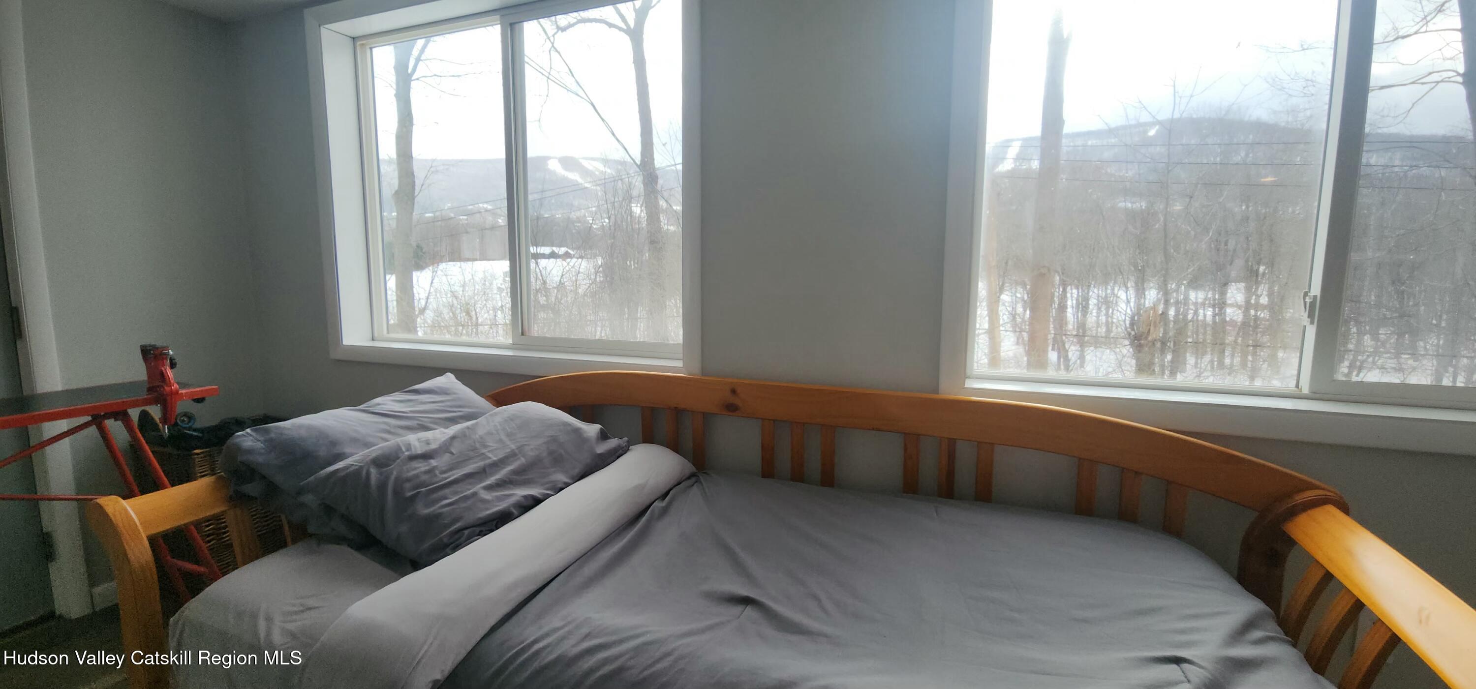 16 Hickory Hill Road Windham, NY 12496 - Photo 18 of 39 a bed sitting in a bedroom next to a window