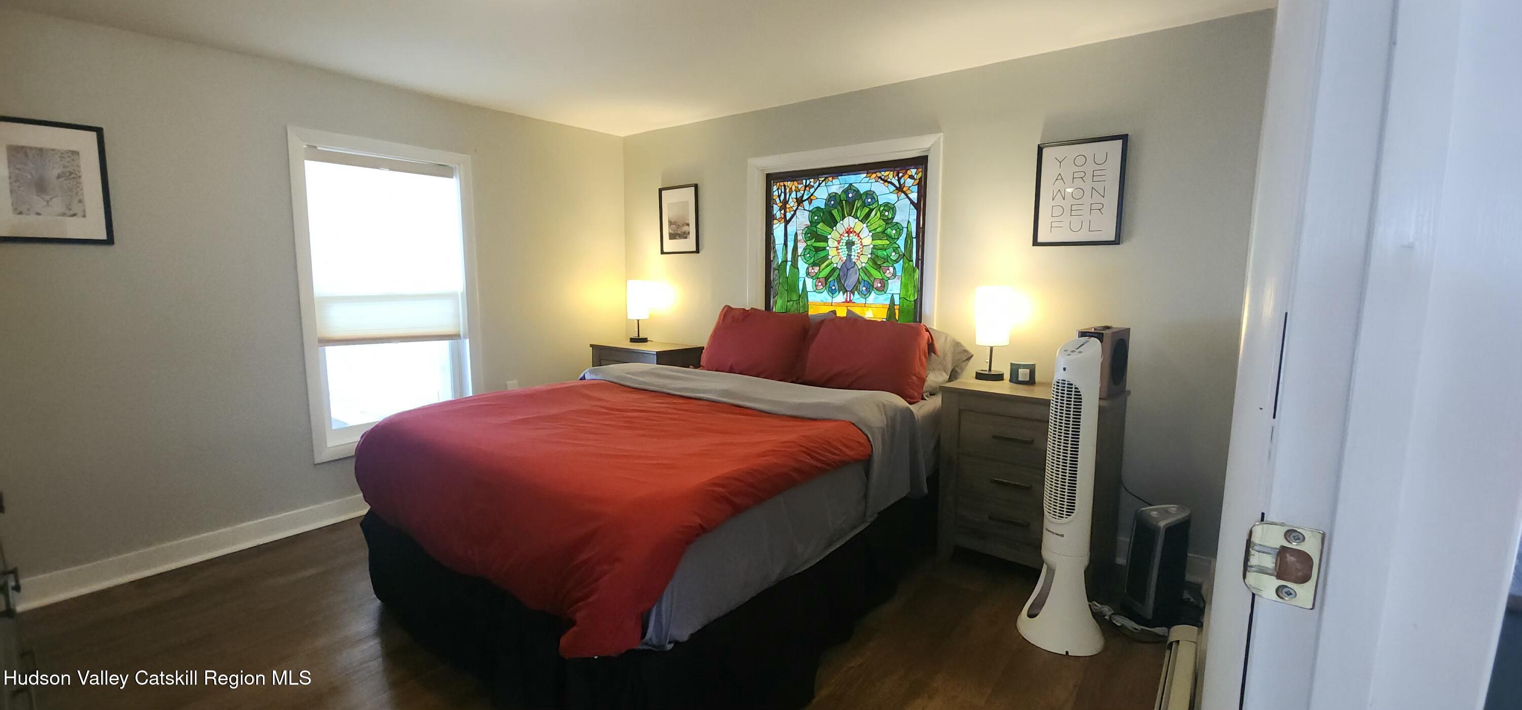 16 Hickory Hill Road Windham, NY 12496 - Photo 19 of 39 a bed sitting in a bedroom next to a window