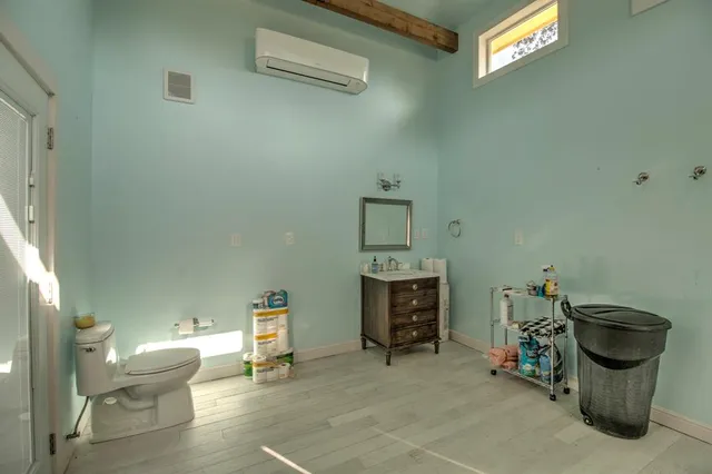 a spacious bathroom with a shower a mirror and a sink