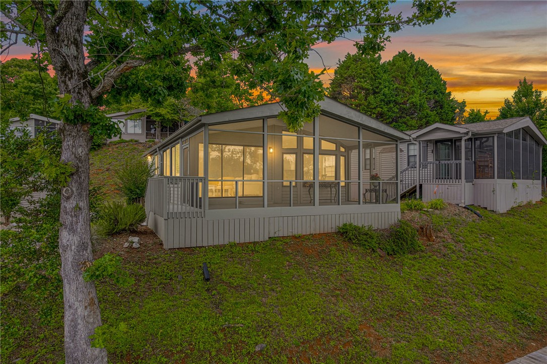 1230 Melton Road, Unit 30 West Union, SC 29696 - Photo 26 of 42 Perched on a verdant hillside, this property features charming screened-in porches, perfect for enjoying twilight views.
