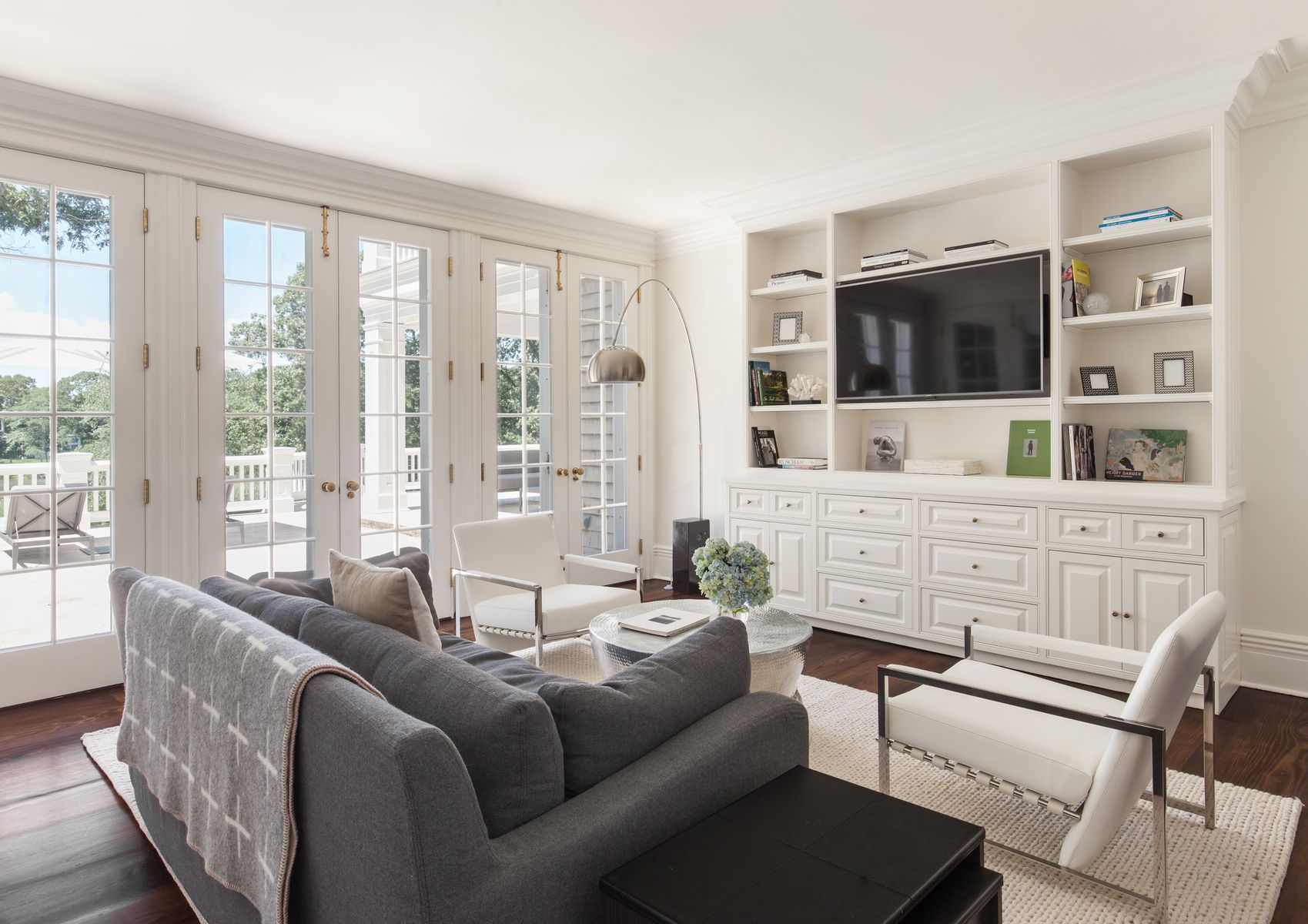 81 Briar Patch Road East Hampton, NY 11937 - Photo 10 of 25 a living room with furniture large windows and wooden floor