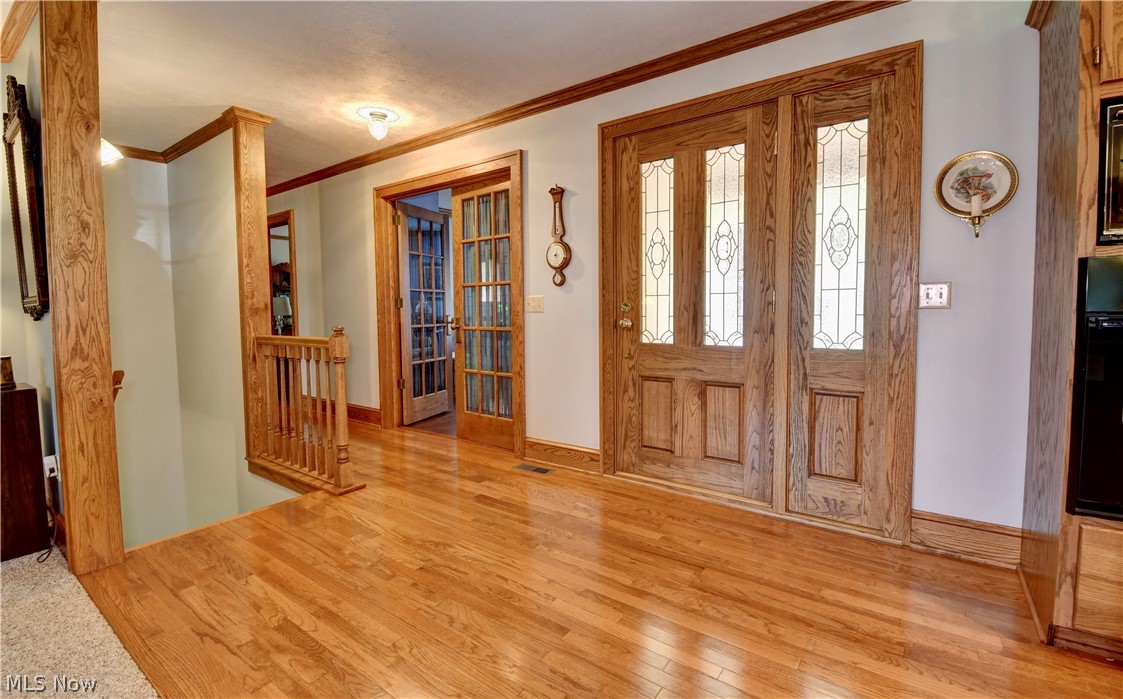 3464 Ridge Road Northwest Strasburg, OH 44680 - Photo 8 of 49 Foyer featuring ornamental molding and light hardwood / wood-style floors