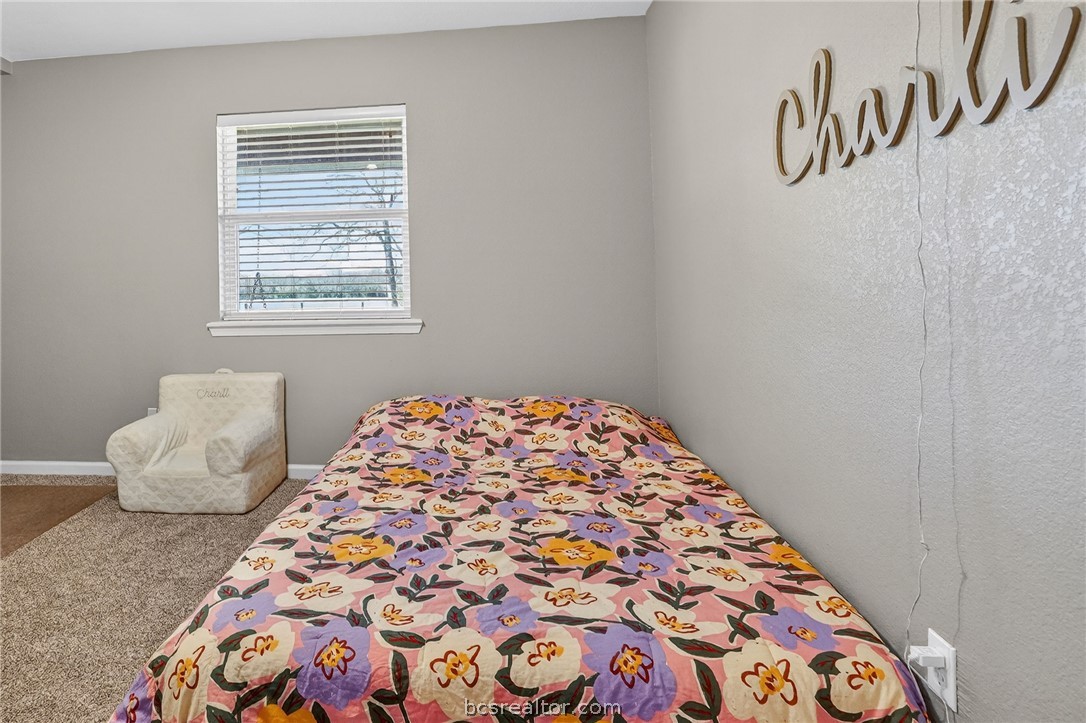 10054 Arnold Lane Bryan, TX 77845 - Photo 11 of 32 a bedroom with a bed and a window