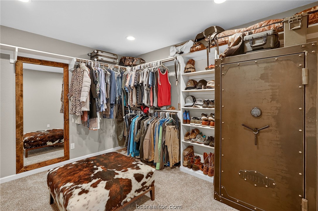 10054 Arnold Lane Bryan, TX 77845 - Photo 24 of 32 a view of walk in closet with clothes and shoes
