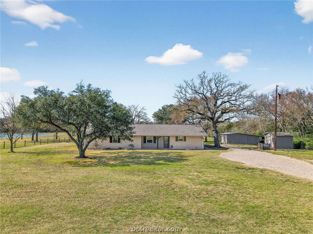 10054 Arnold Lane Bryan, TX 77845 - Photo 30 of 32 a house view with swimming pool and trees in the background