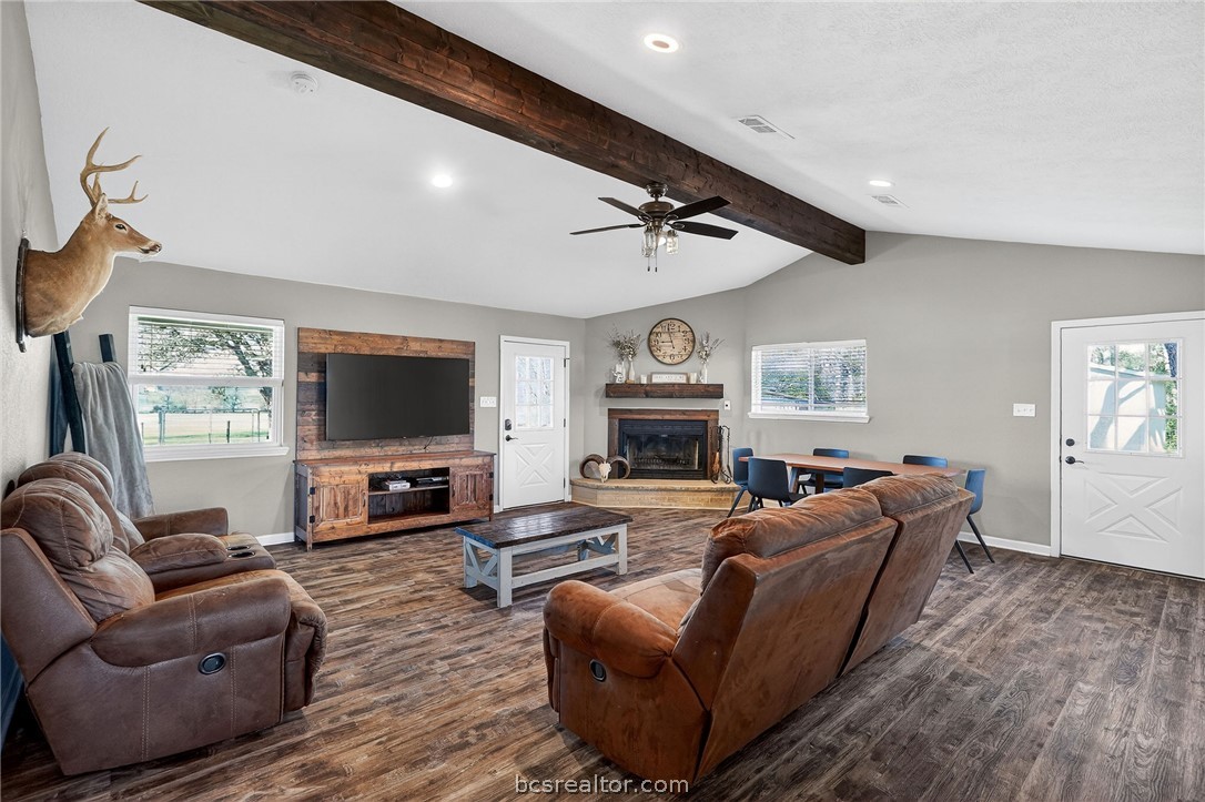 10054 Arnold Lane Bryan, TX 77845 - Photo 3 of 32 a living room with furniture a flat screen tv and a fireplace