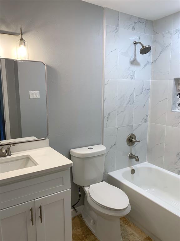 8601 Park Lane, Unit 414 Dallas, TX 75231 - Photo 12 of 23 a bathroom with a sink a toilet and shower