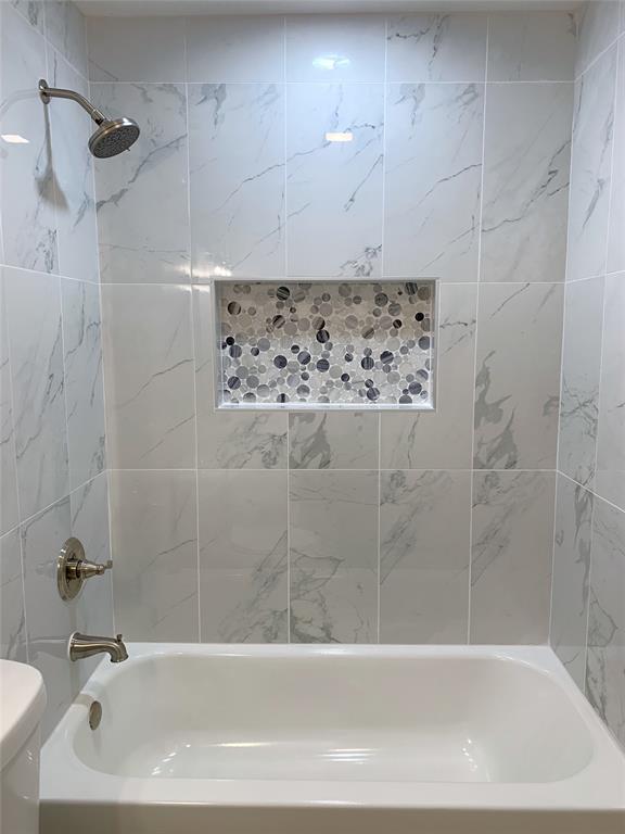 8601 Park Lane, Unit 414 Dallas, TX 75231 - Photo 13 of 23 a bathroom with a bathtub and shower