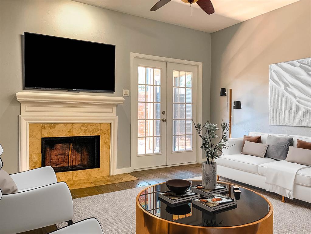8601 Park Lane, Unit 414 Dallas, TX 75231 - Photo 3 of 23 a living room with furniture a flat screen tv and a fireplace