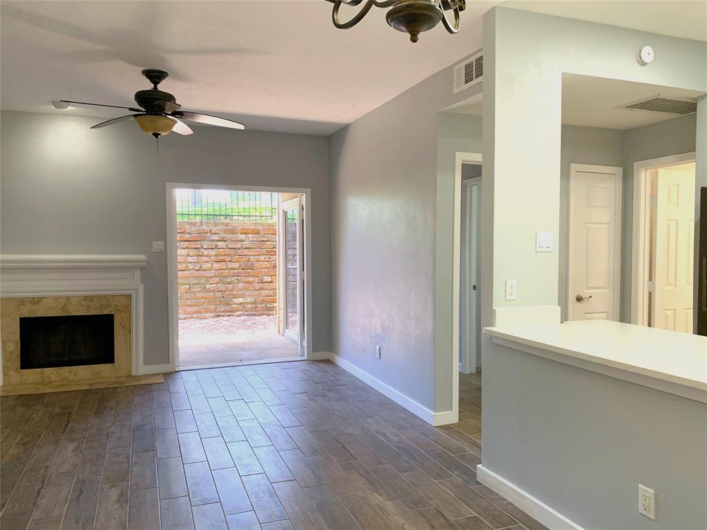 8601 Park Lane, Unit 414 Dallas, TX 75231 - Photo 6 of 23 a view of an empty room with wooden floor and a window