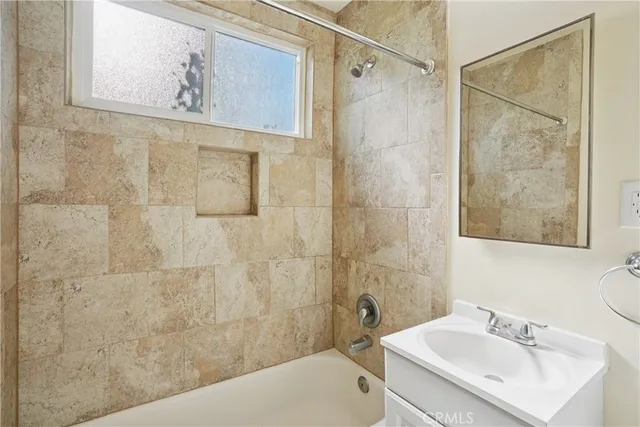 a bathroom with a sink a mirror and a shower