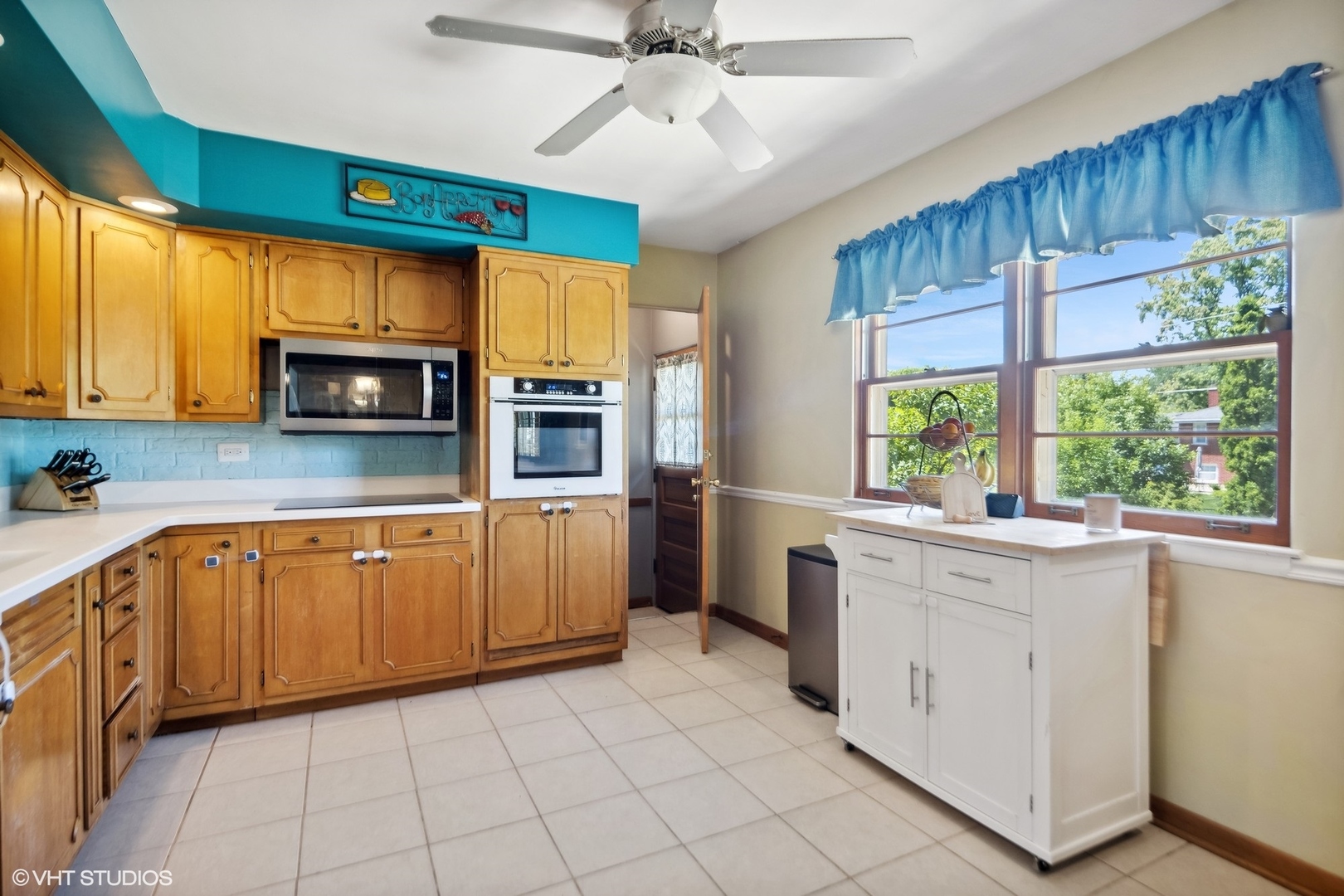 250 East Harrison Road Lombard, IL 60148 - Photo 11 of 32 a kitchen with a stove a sink and a microwave