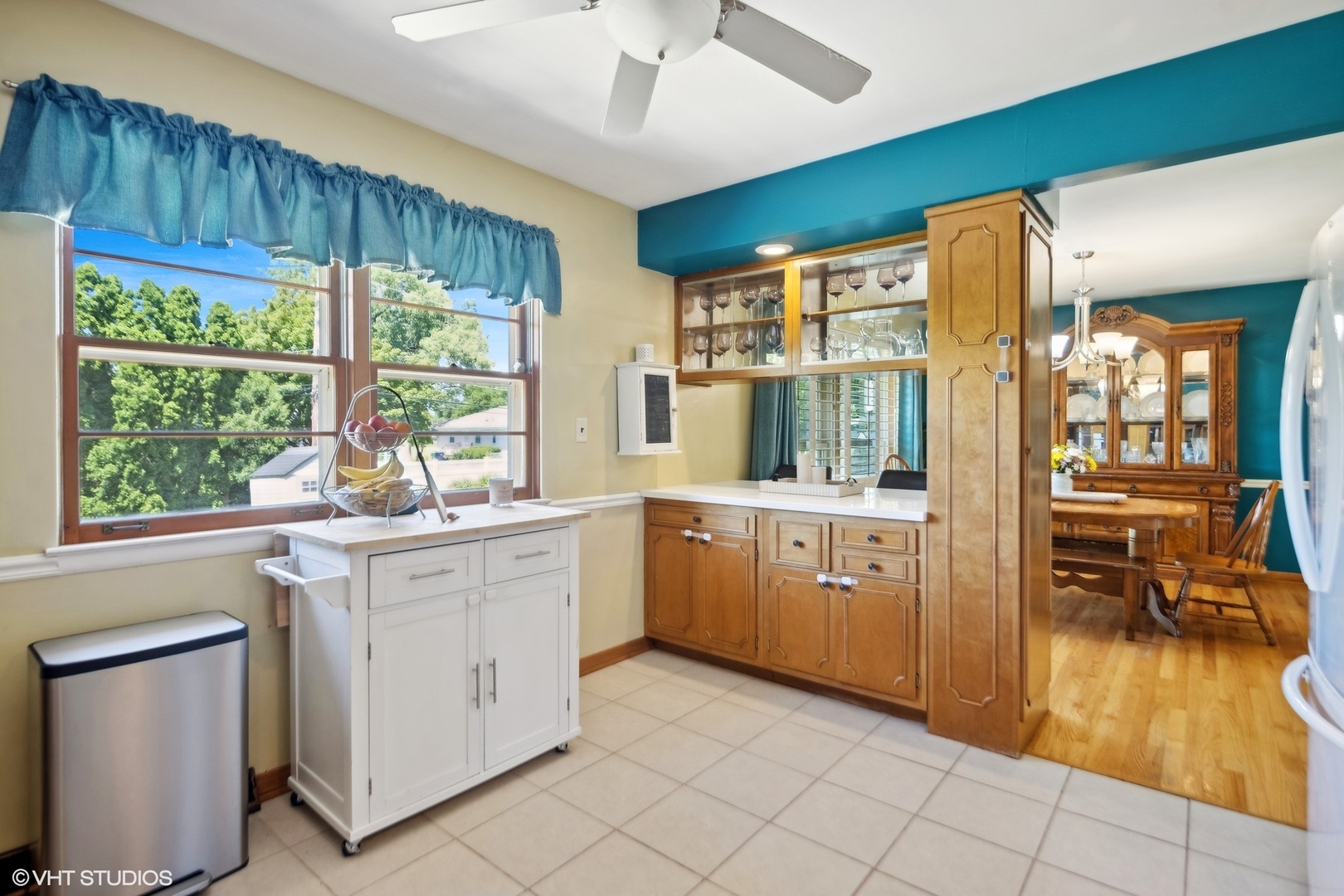 250 East Harrison Road Lombard, IL 60148 - Photo 13 of 32 a kitchen with a refrigerator and white cabinets