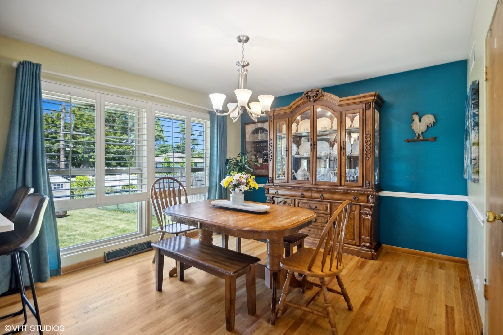 250 East Harrison Road Lombard, IL 60148 - Photo 8 of 32 a dining room with furniture a chandelier and wooden floor