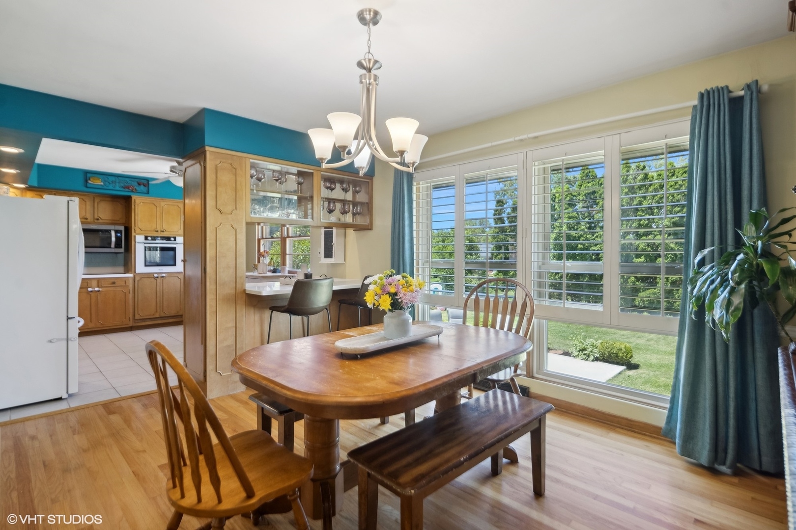 250 East Harrison Road Lombard, IL 60148 - Photo 9 of 32 a dining room with furniture a chandelier and wooden floor