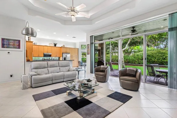 a living room with furniture and floor to ceiling windows