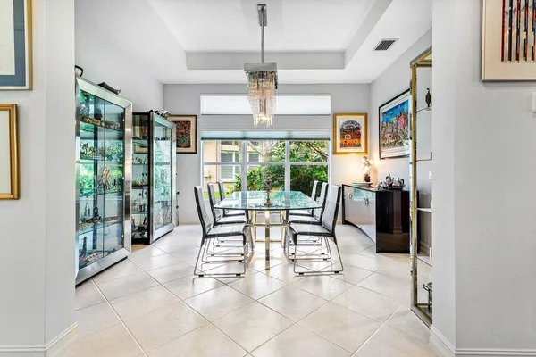 a dining room with furniture and large windows